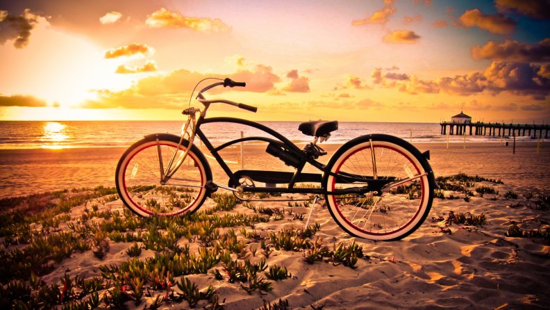 vintage bicycle on a beach at sunset