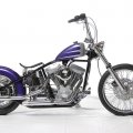 Purple and silver harley with a solo seat